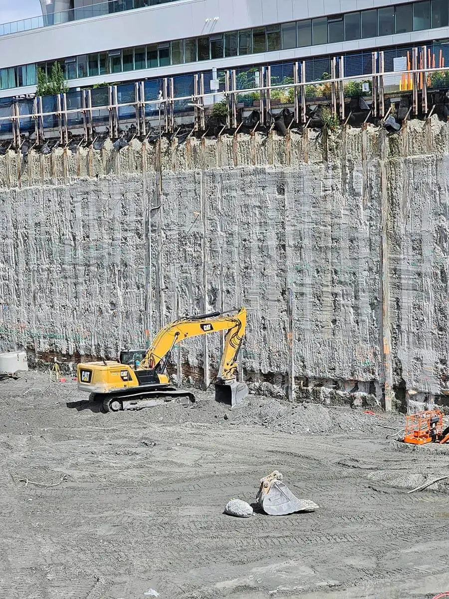 Excavator working the base of the deep excavation