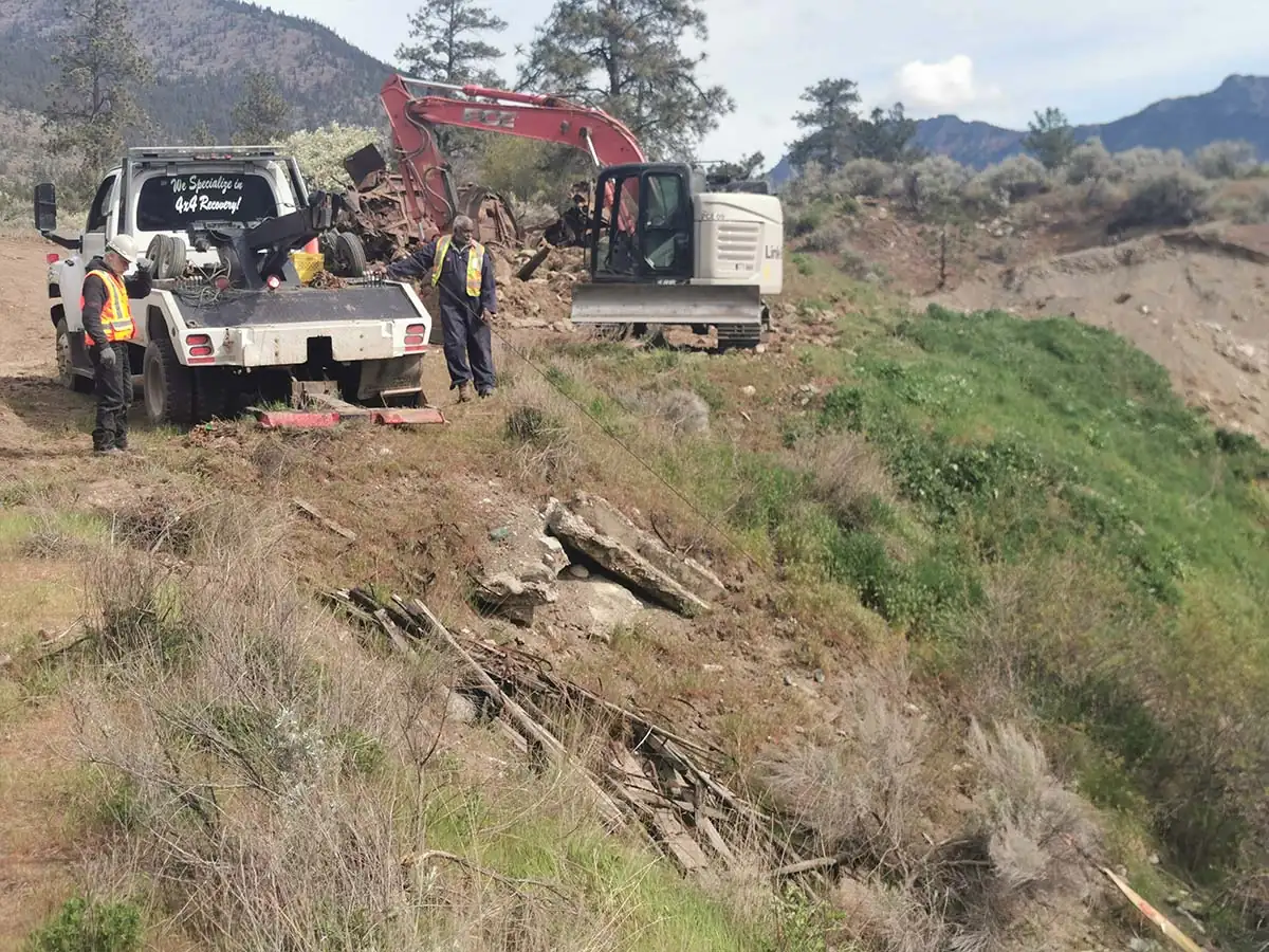 Crew and trucks loading recovered vehicles