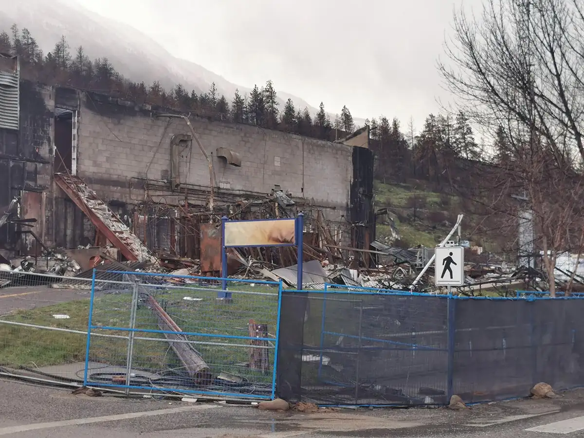 Fenced burned commercial building on the main road