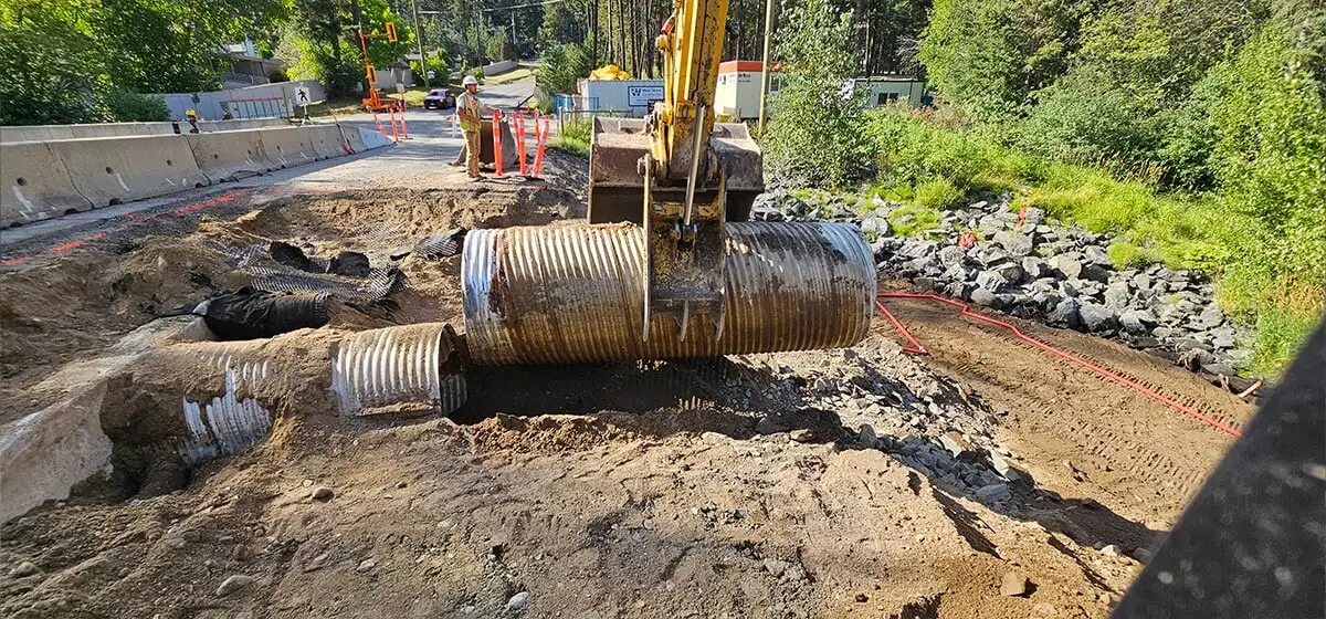 Corrugated pipe and excavation at the creek