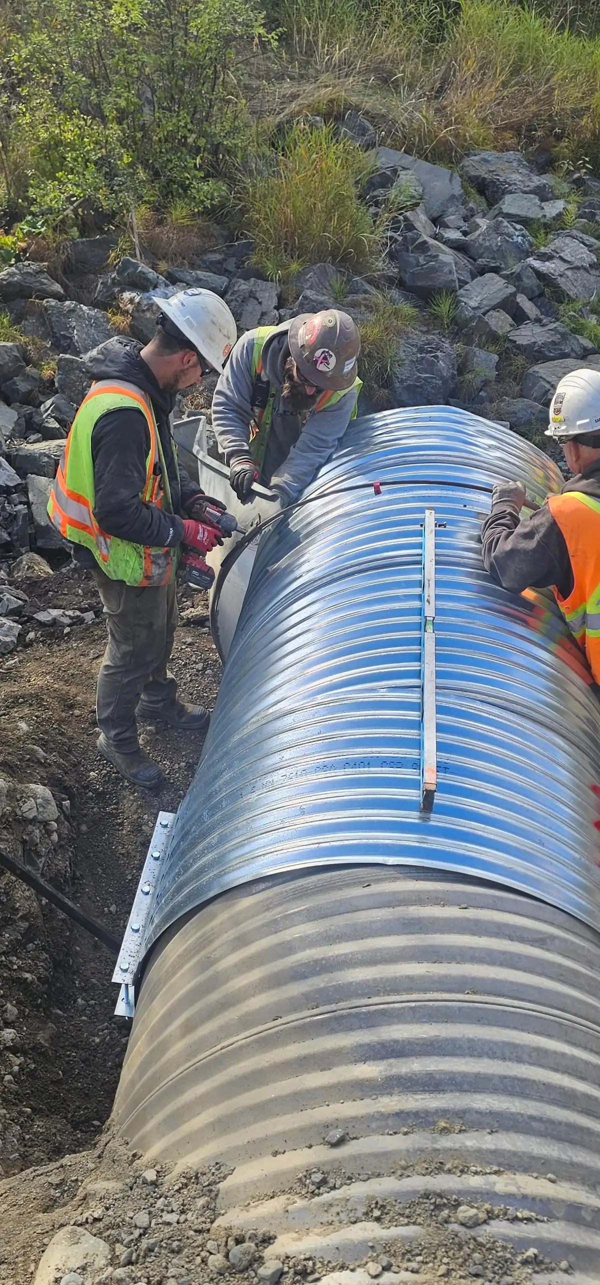 Crew setting large-diameter corrugated steel pipe