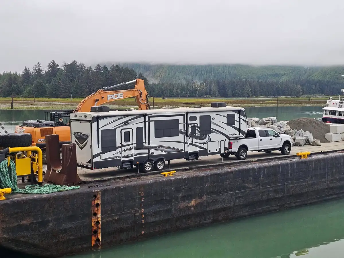Crew RV, pickup and PCE excavator on the barge deck