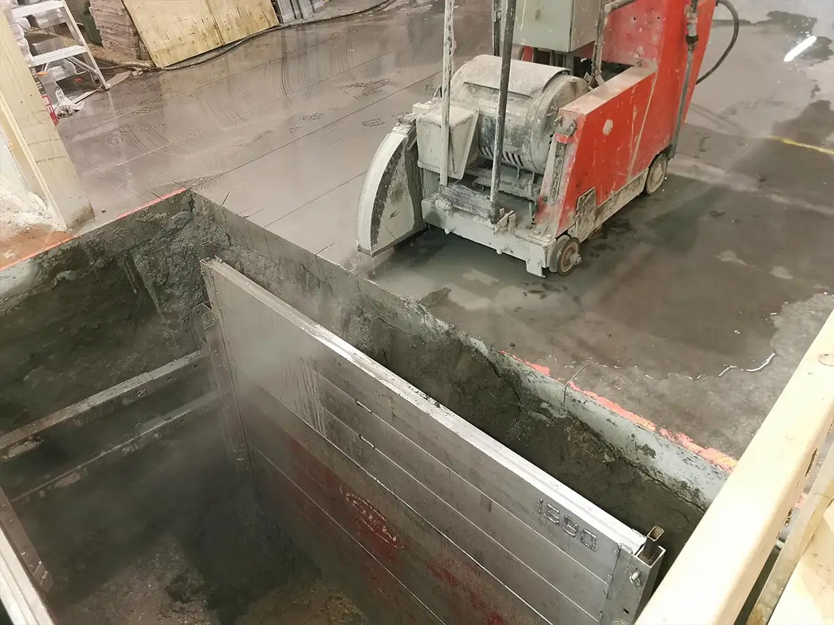 Saw-cut floor and shoring panel at the top of the excavation